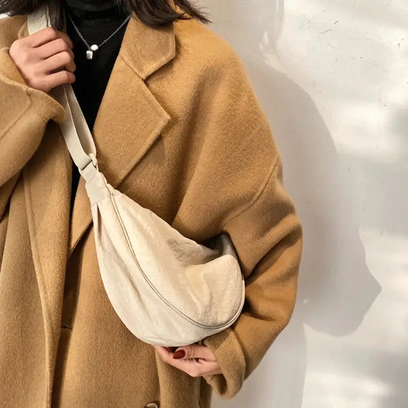 Casual nylon hobo crossbody bag in beige with a long adjustable strap and large-capacity design.