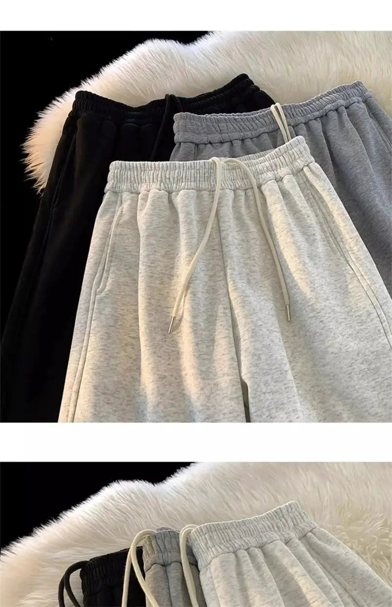Set of four men's heavy-duty sweatpants in black, charcoal, gray, and light gray with drawstring waists.