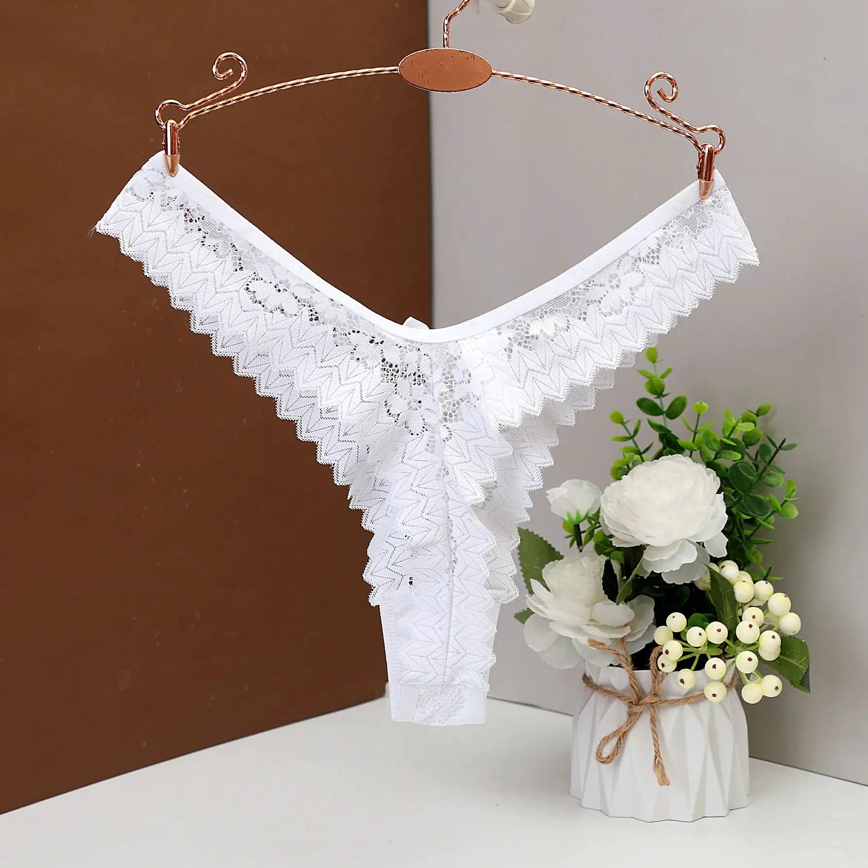 Women's white lace thong underwear on a copper hanger, low-waist lingerie by Simples Market