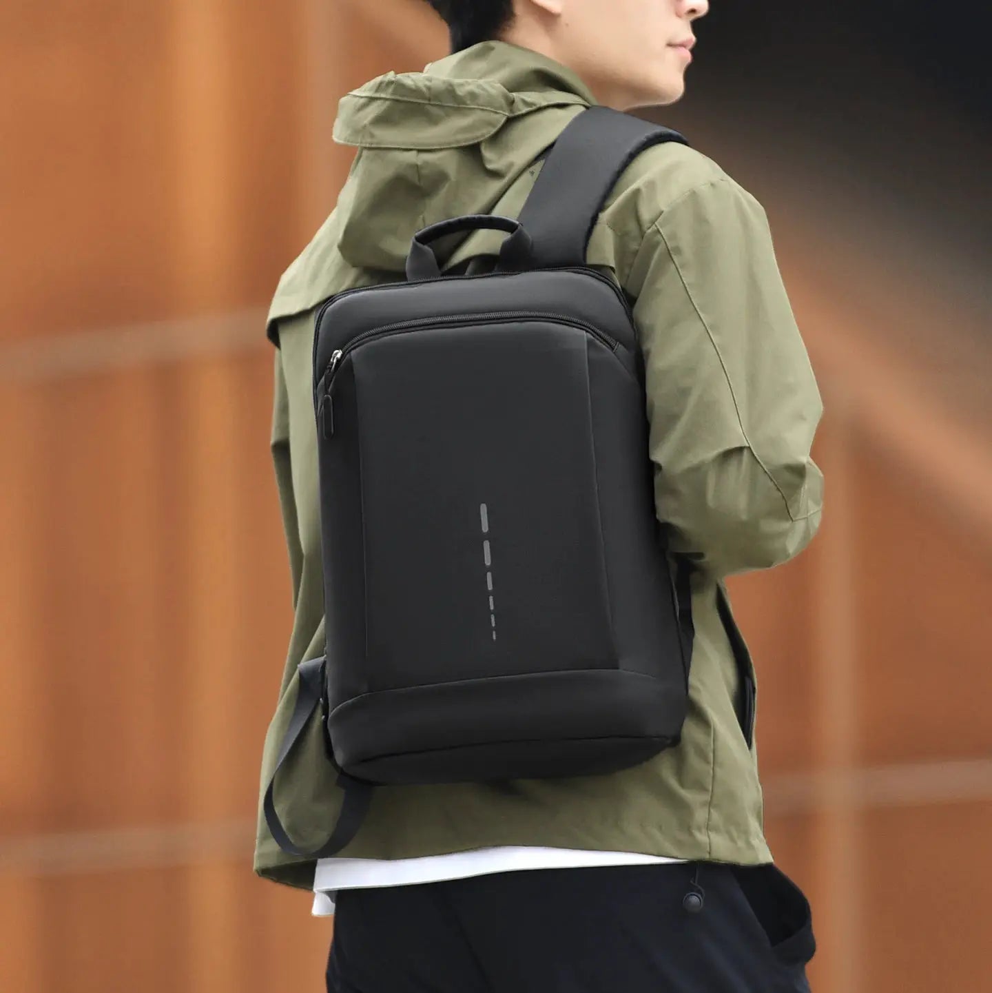 A person wearing an ultra-lightweight 15.6-inch laptop backpack, ideal for business commutes and travel.