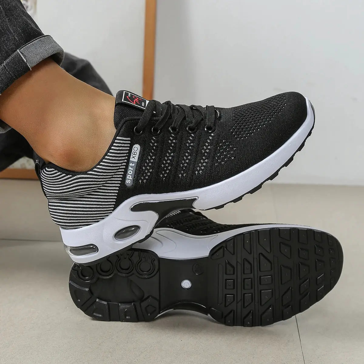 Men's black breathable knit lace-up running shoes with white midsole and non-slip outsole.