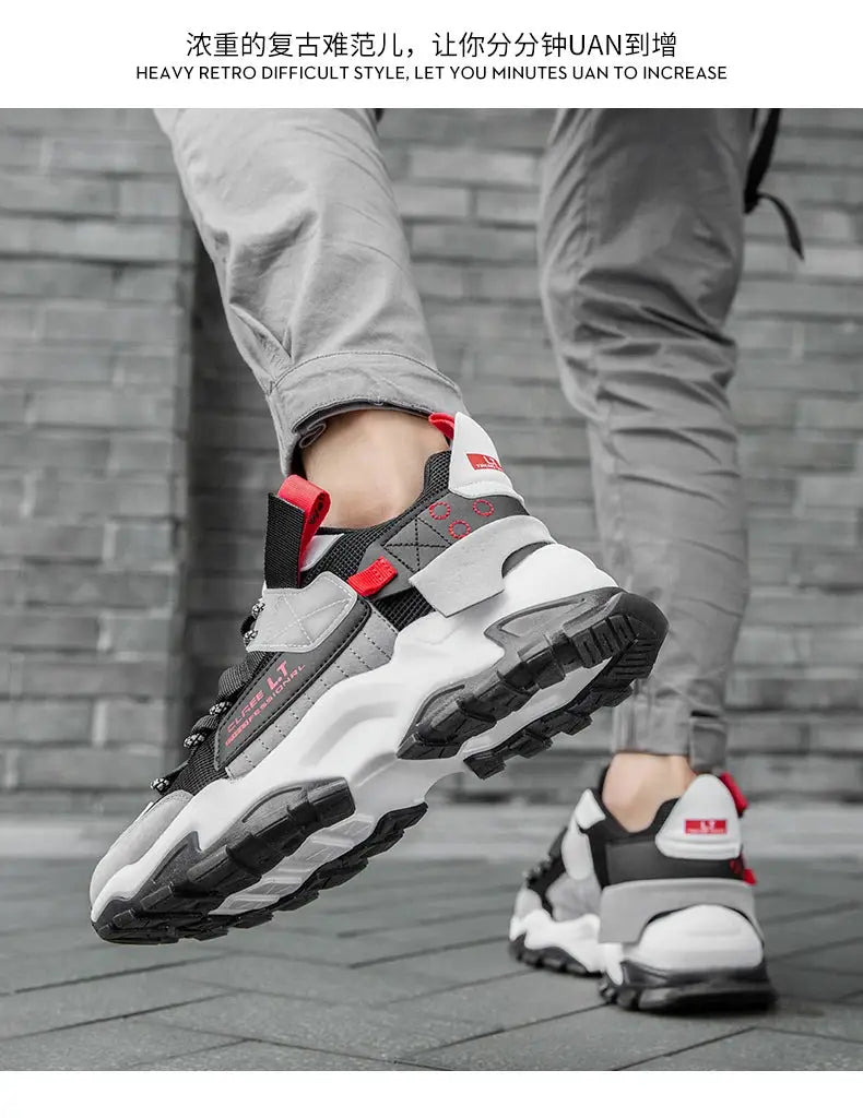 Pair of men's sneakers by Simples Market; gray/black athletic shoes with red accents and a chunky outsole