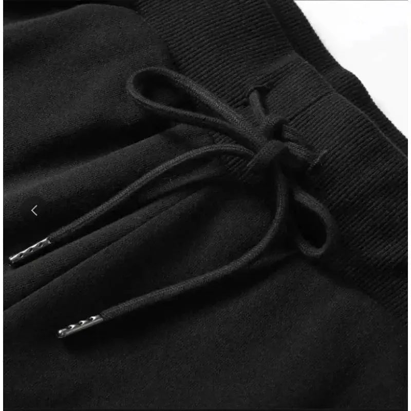 Black 100% cotton shorts with drawstring waist and metal-tipped aglets.