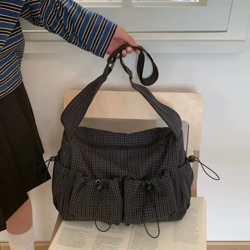 Korean nylon shoulder bag in dark plaid with front drawstring pockets