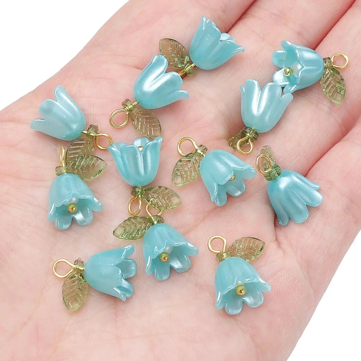 Lily-of-the-valley 11x14mm acrylic beads, blue with gold loops and translucent leaves, several pieces