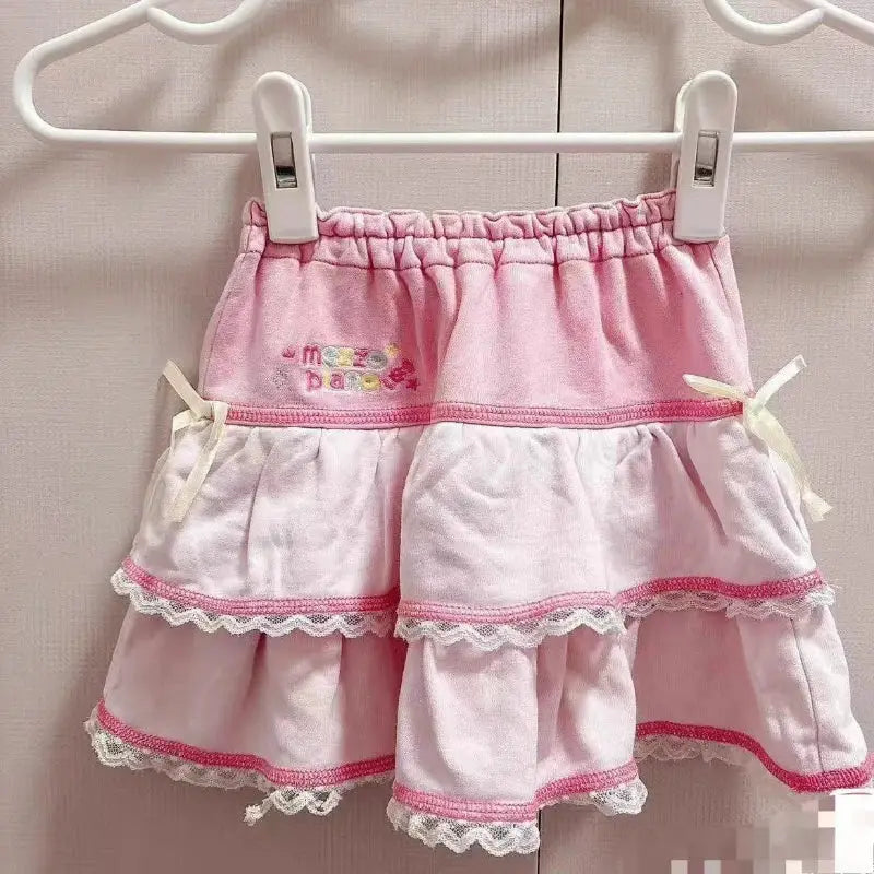 Sweet Lolita cake mini skirt by Simples Market, pink layered design with white lace trim and bow accents