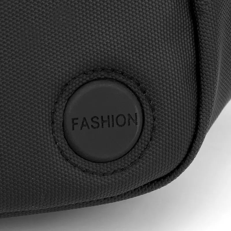 Unisex waterproof waist bag in black fabric with a round fashion patch on the front