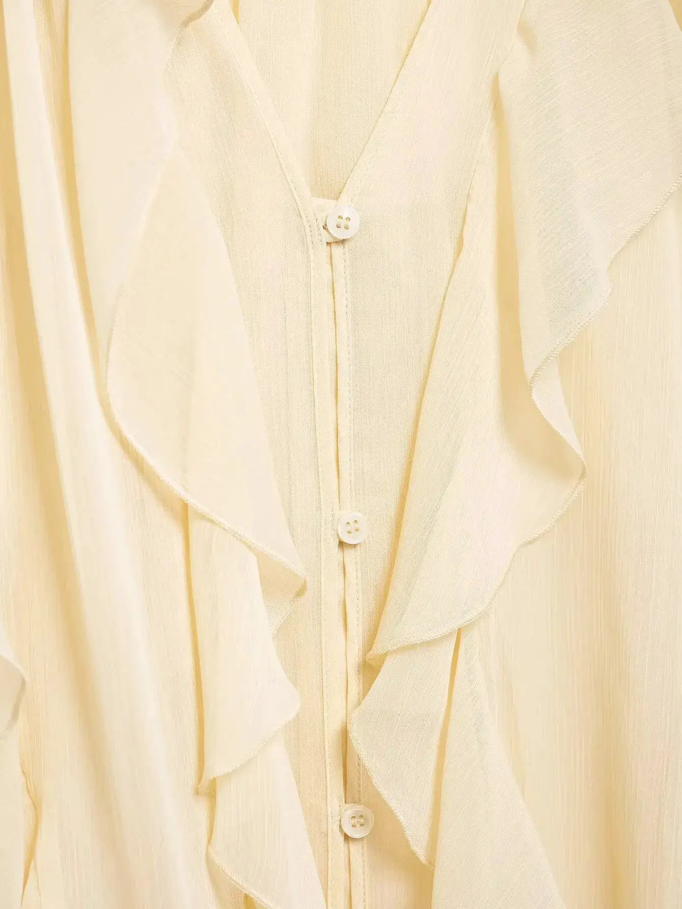 Women's ivory ruffled blouse with button-down front and soft sheer fabric