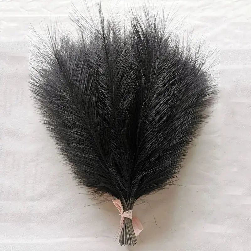 Artificial pampas grass bouquet, fluffy black reeds tied with pink ribbon for boho decor