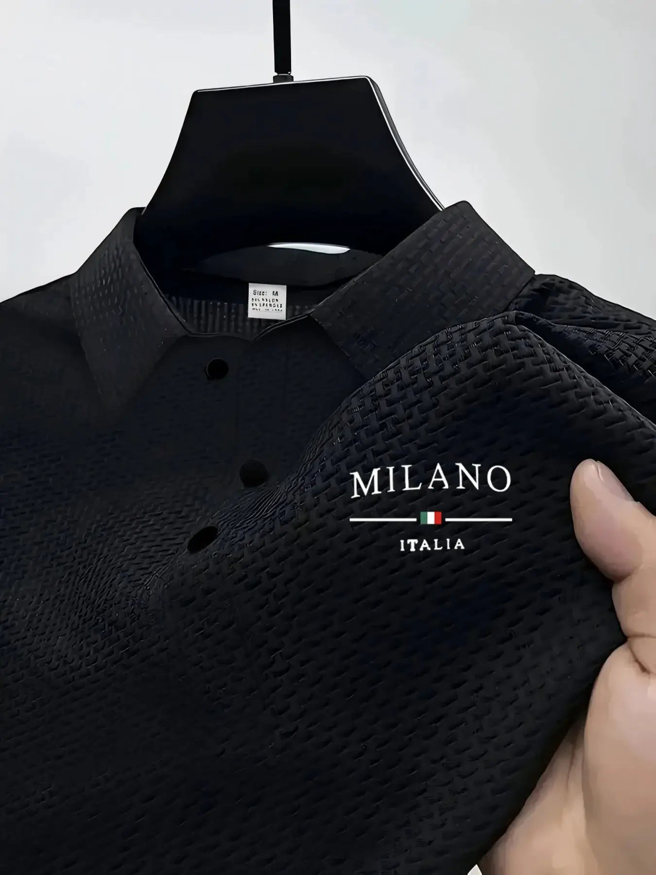 Black textured polo shirt on a hanger with Milano Italia logo
