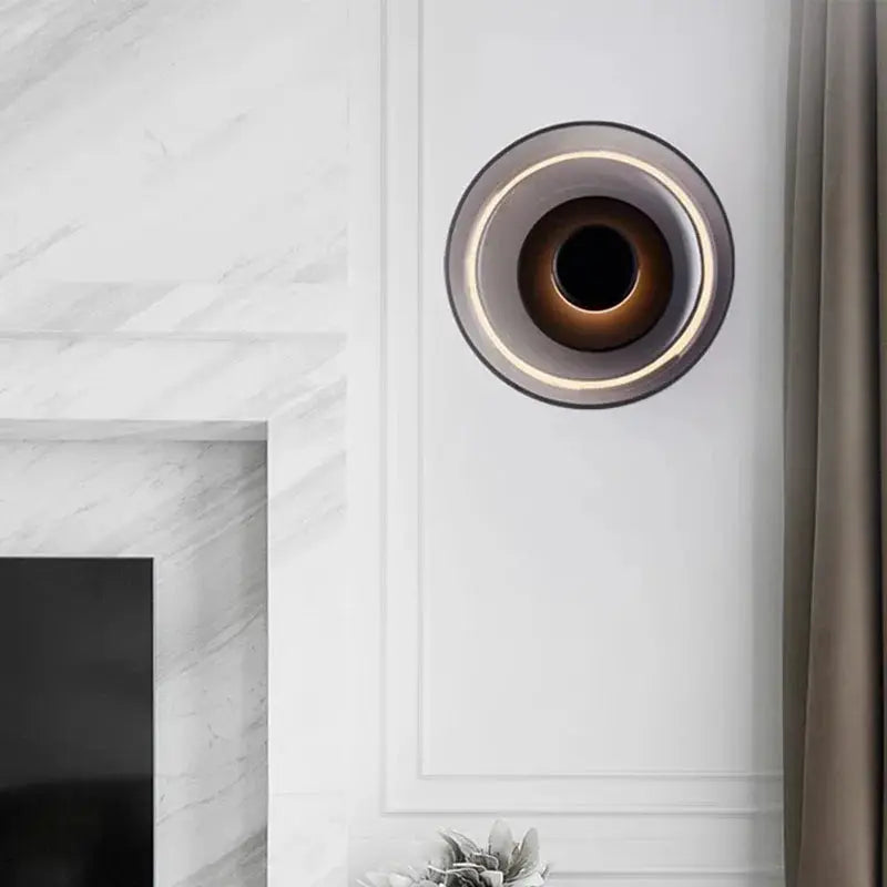 Nordic LED glass wall sconce with circular ring light mounted on a white wall