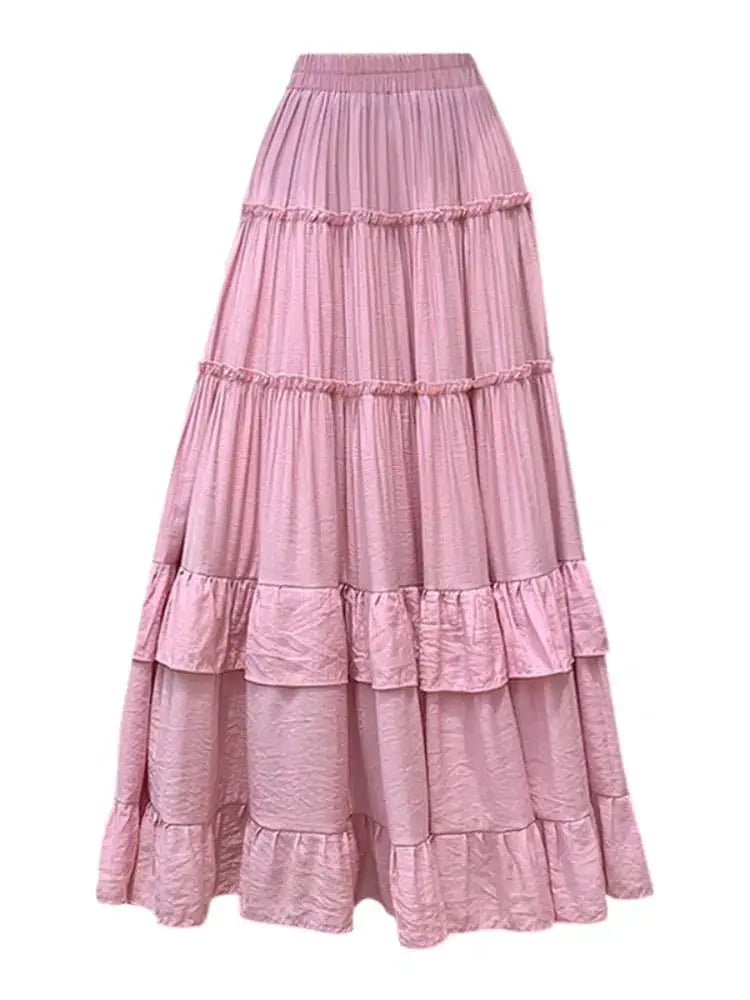 Pink chiffon tiered maxi skirt with high waist and ruffle tiers in flowing A-line silhouette by Simples Market.