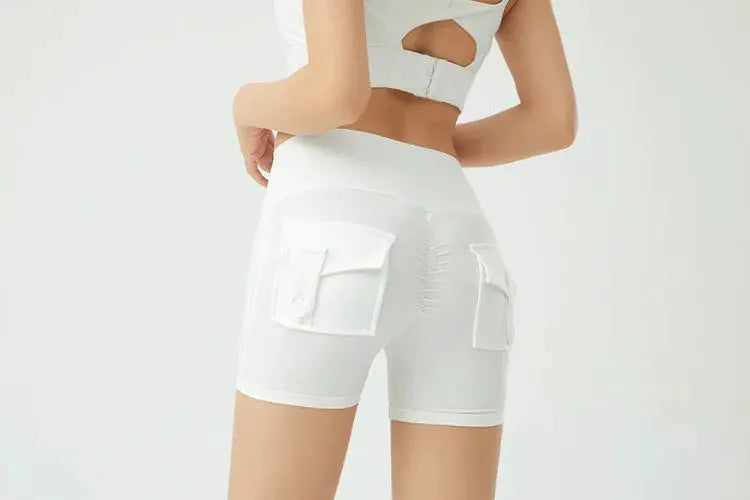 White women's fitness shorts with cargo pockets, three-quarter length, air-dry fabric, tight fit.