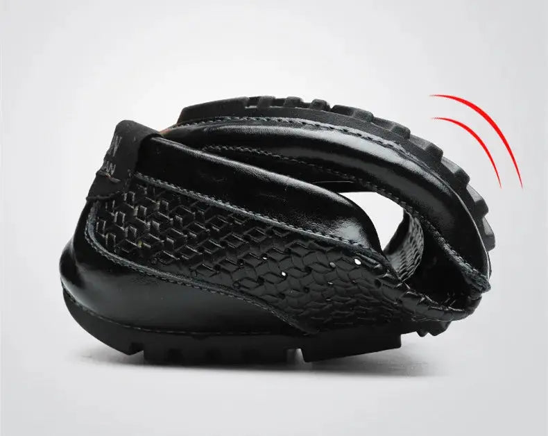 Men's black leather loafers by Simples Market with hollow-out pattern and rugged driving sole.