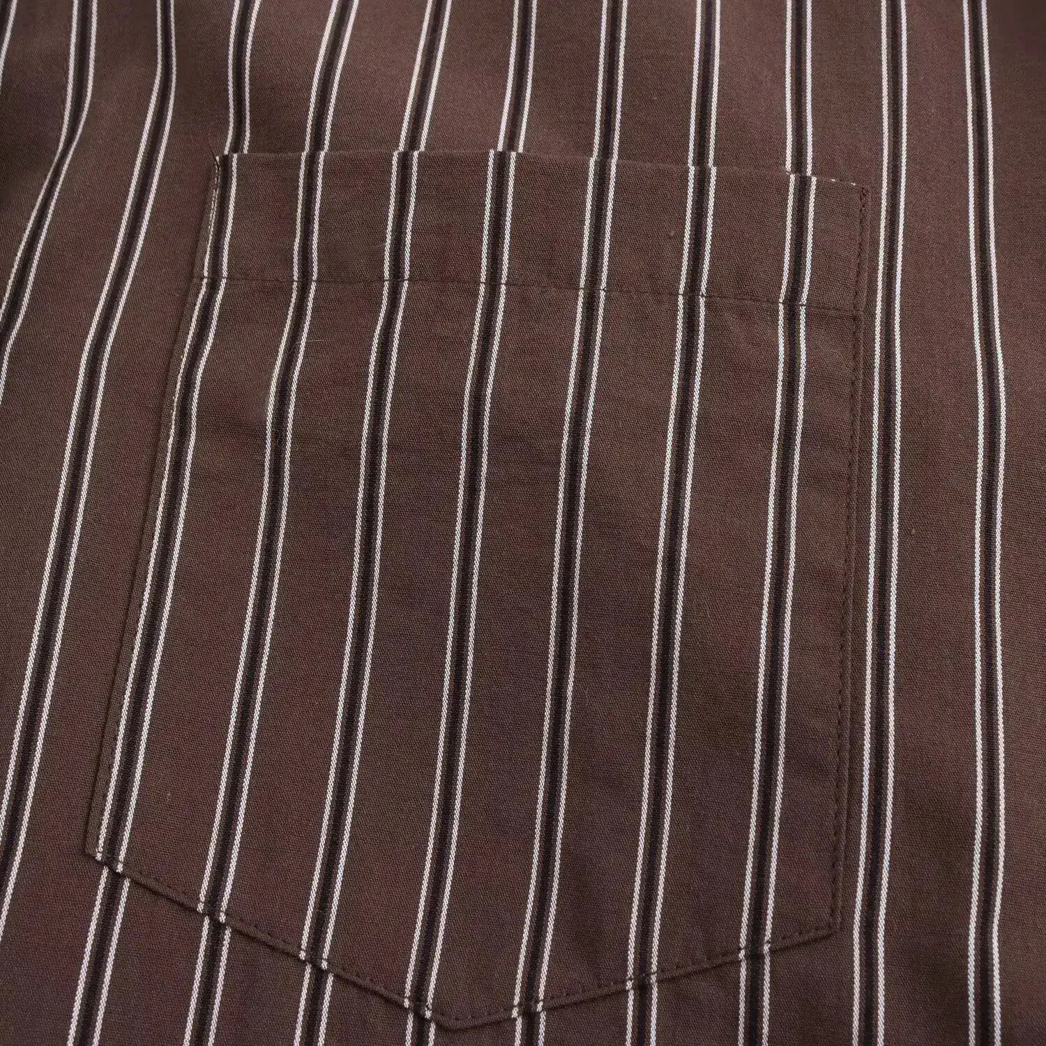 Brown striped blouse with white vertical stripes and a front pocket.