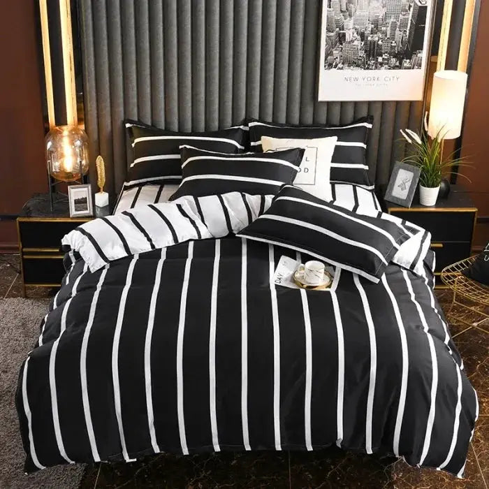 Simples Market four-piece black and white striped cotton bedding set on a bed, including duvet cover and pillowcases.