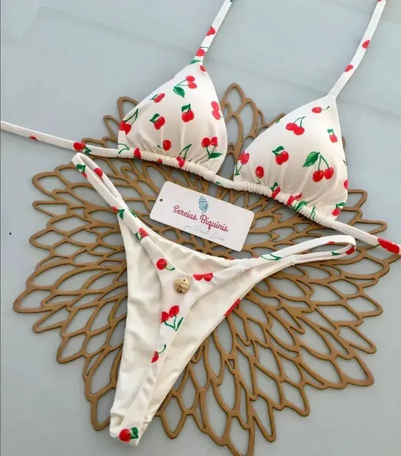 Bikini set by Simples Market, white cherry-print halter top with thong bottom.
