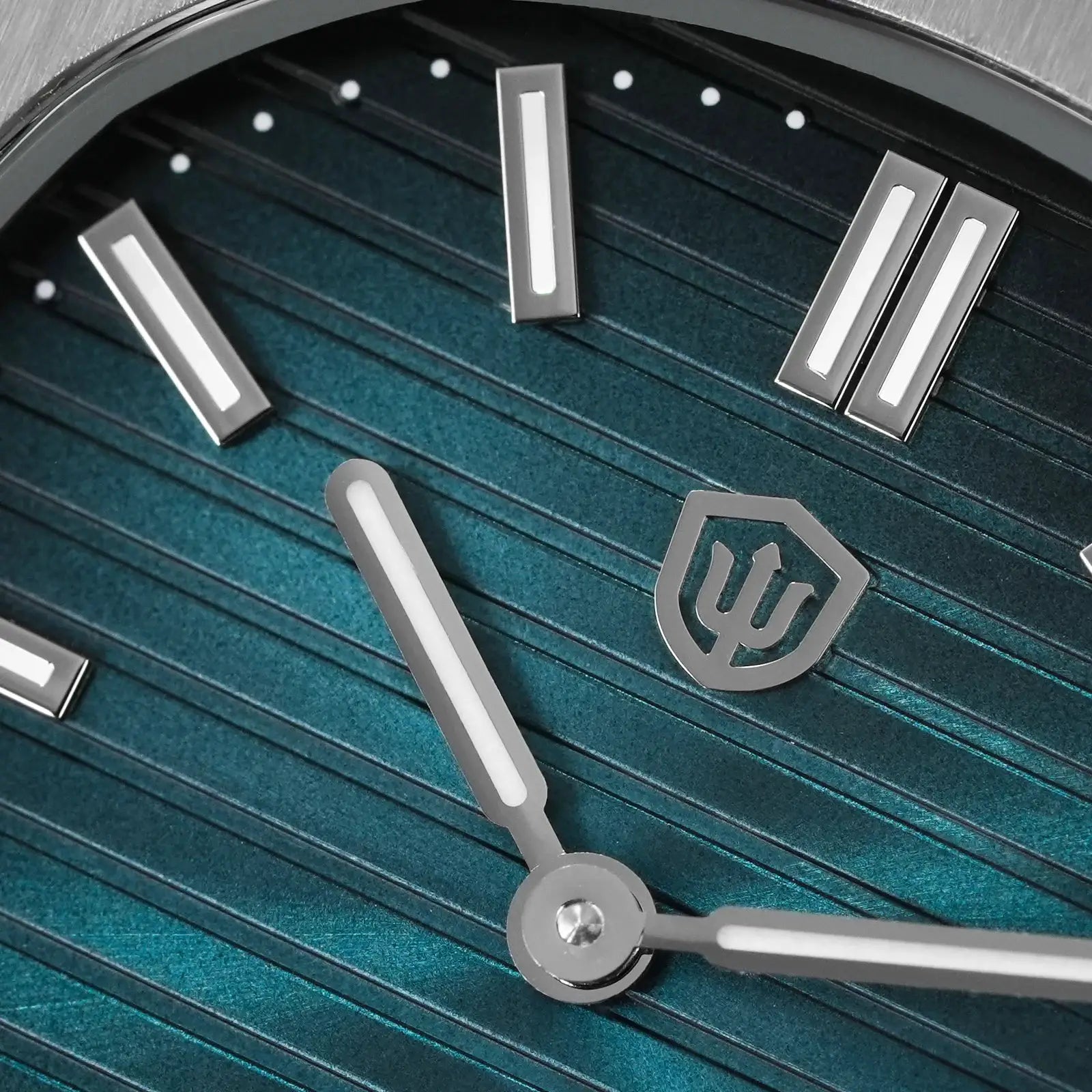 Watch components: silver baton hour markers and hands on teal dial with Watchdives WD logo