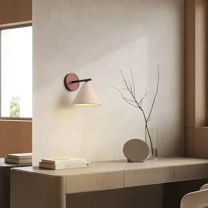 Travertine wall lamp sconce with cone shade and warm yellow LED lighting