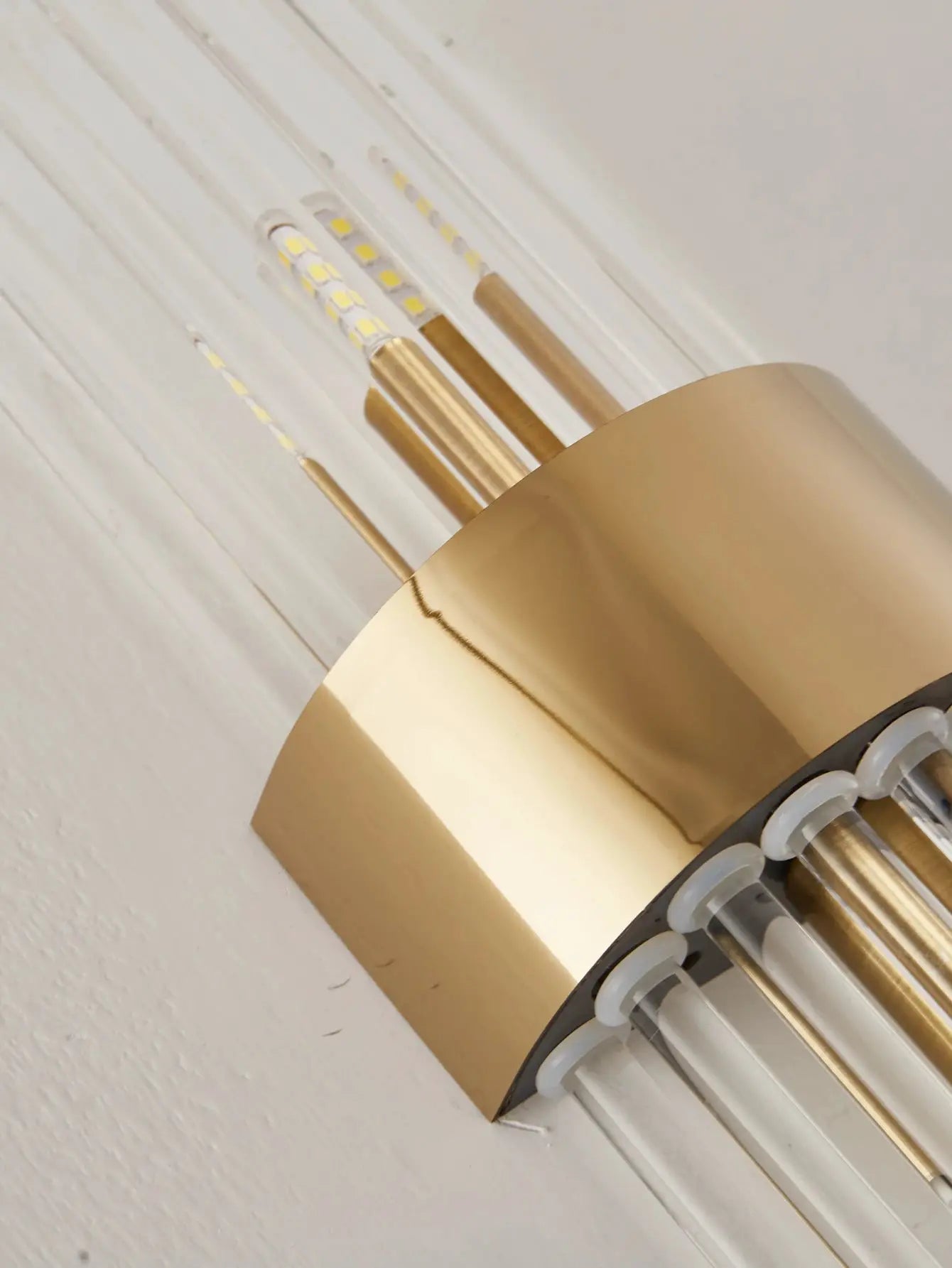 Gold stainless steel crystal wall sconce with clear LED tubes by Simples Market
