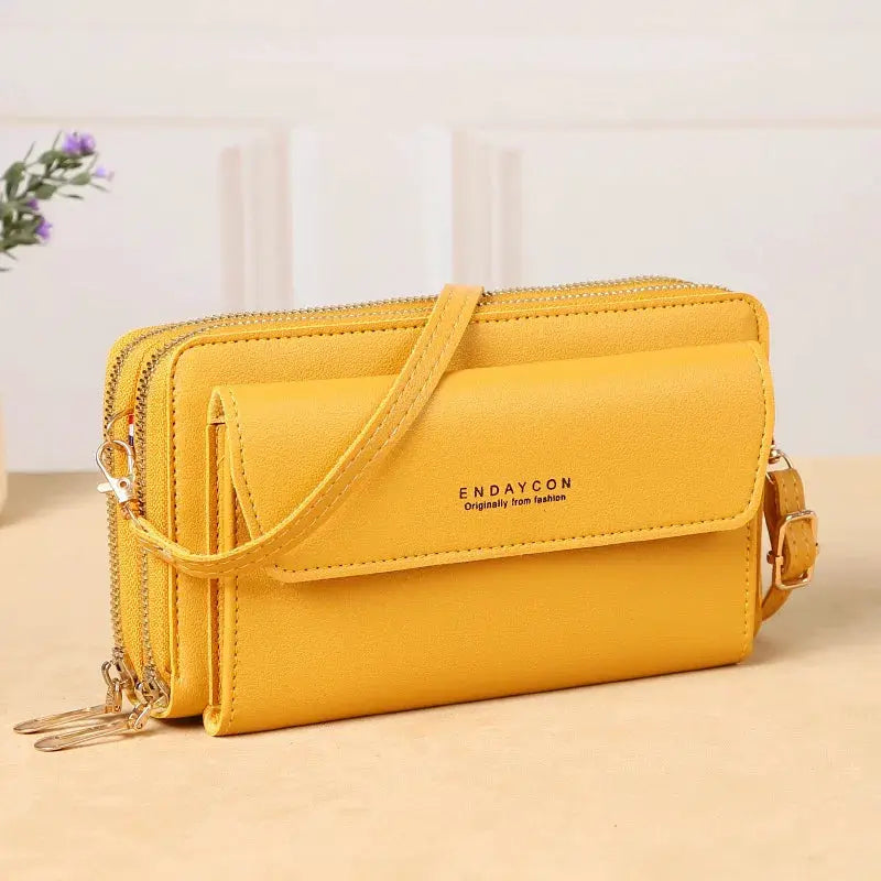 Yellow crossbody bag with double zipper compartments and adjustable strap; ENDAYCON logo on front