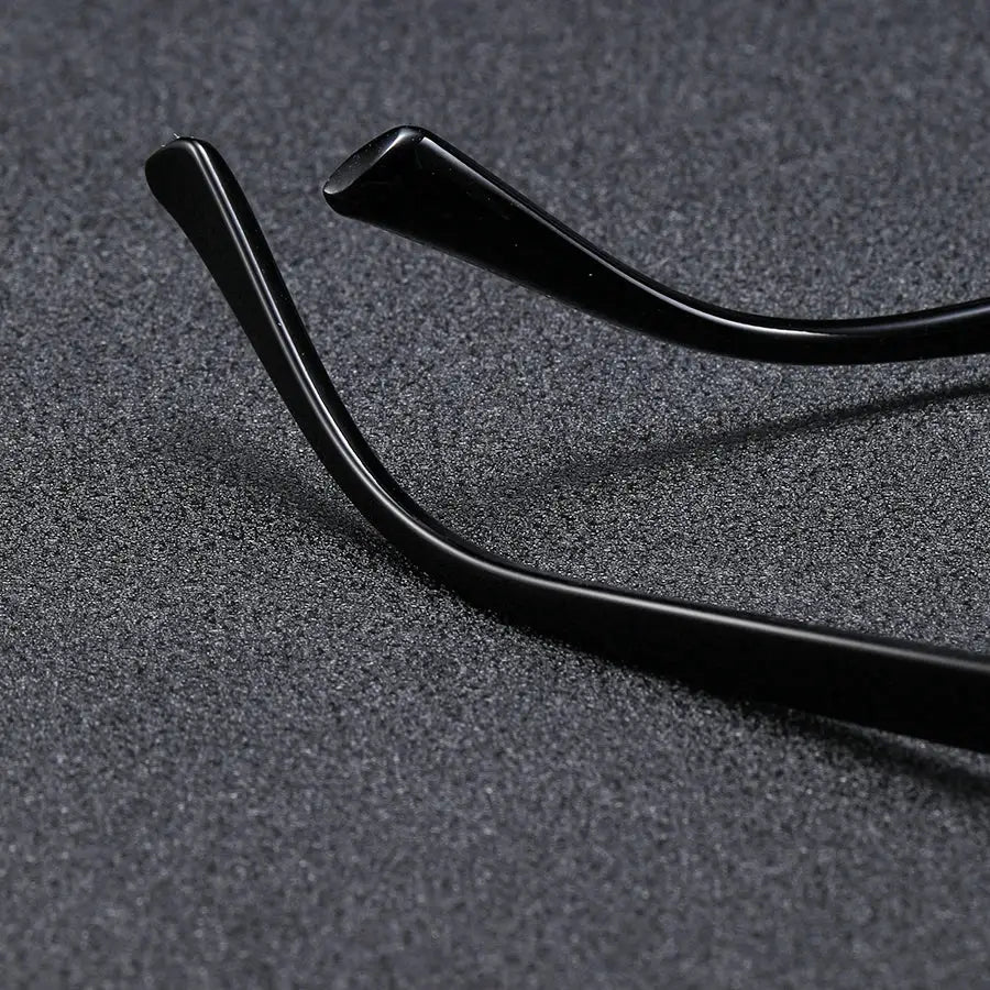 Men's black square-frame glasses with glossy temple arms, close-up