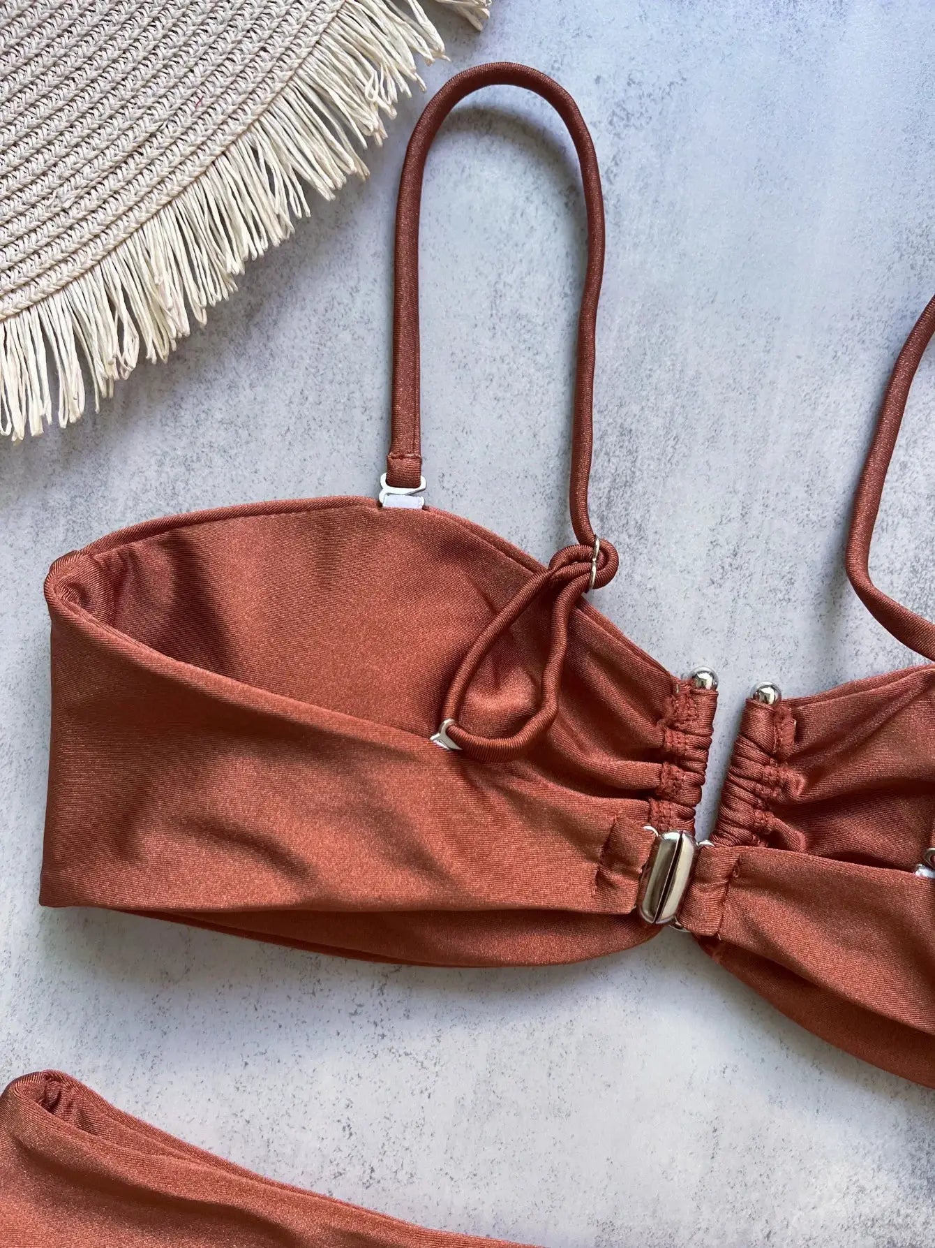 Bandeau bikini top by Simples Market in rust orange with adjustable straps and metal hardware