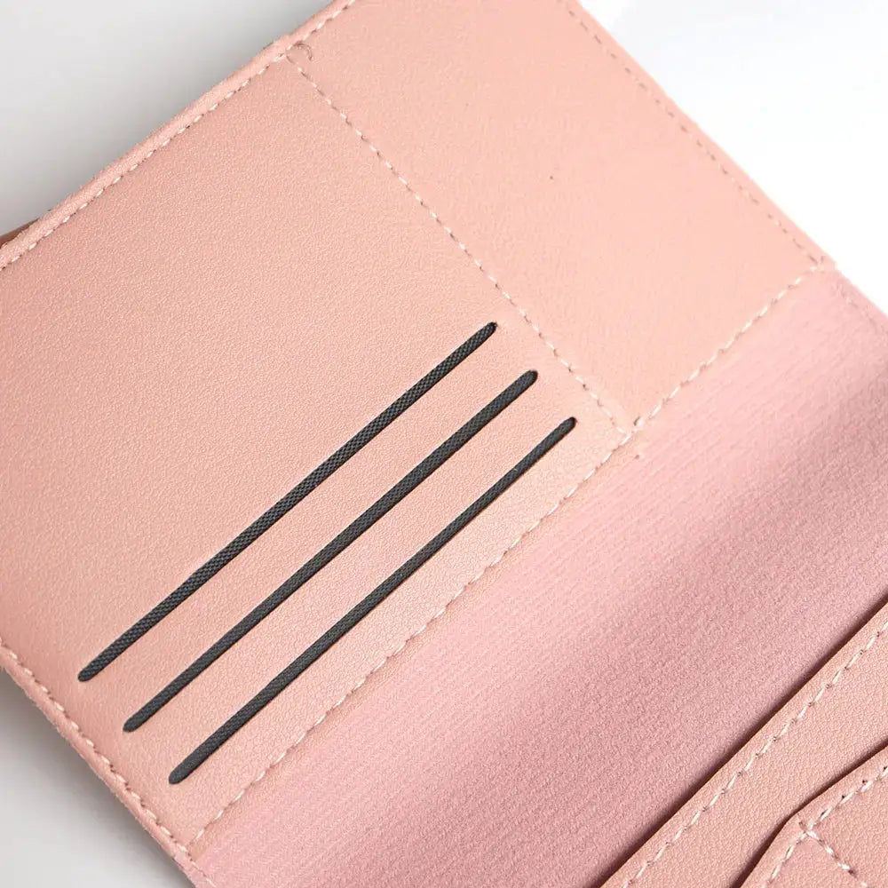 Pink leather travel passport cover with three card slots and stitched edges.