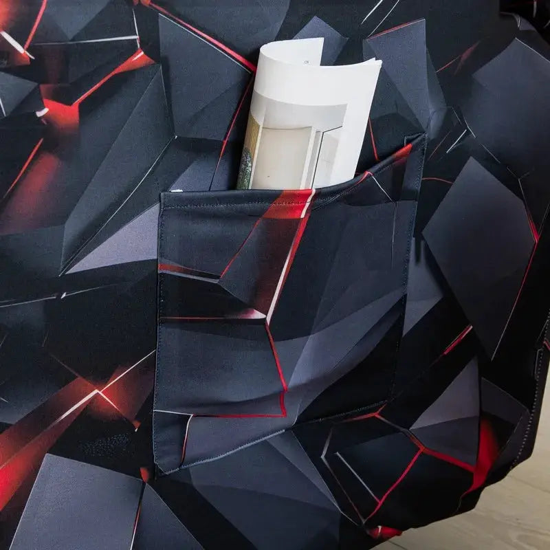 Stretch recliner couch cover with dark geometric print and front pocket holding a magazine