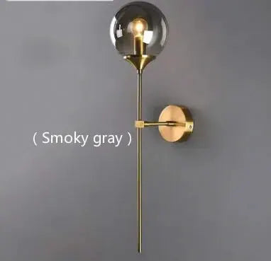Modern Glass Wall Lamp by Simples Market, gold brass finish with a clear glass globe for living room or bedside