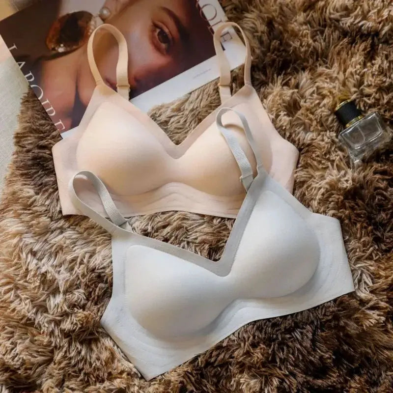 Seamless women's bras, nude and white, two-piece set with soft support.