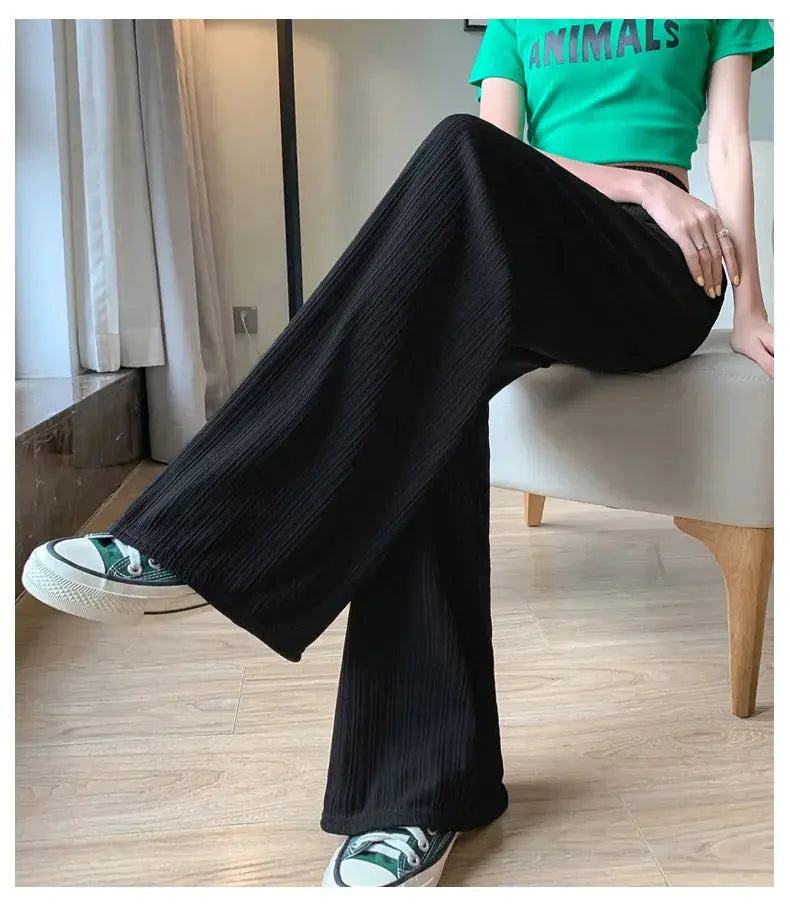 Black wide-leg pants with subtle vertical pleats, long length for casual wear.