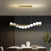 Nordic ceiling chandelier by Simples Market; gold bar with white globe lights for living room or dining area.