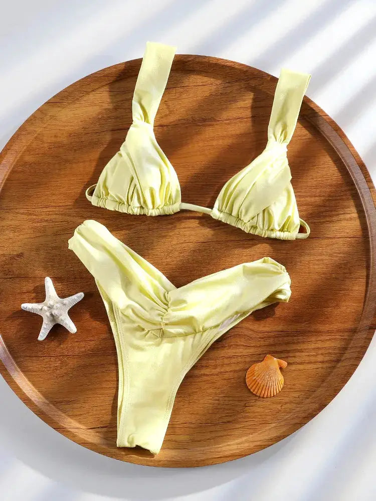 Bikini set: yellow string two-piece with ruffle-trim top and high-cut bottom.