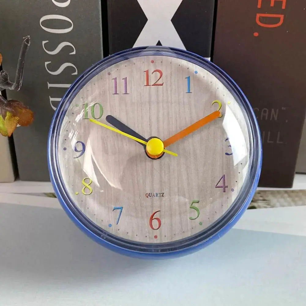 Simples Market mini wall clock, 7cm with blue frame, wood-grain dial and colorful rainbow numerals.