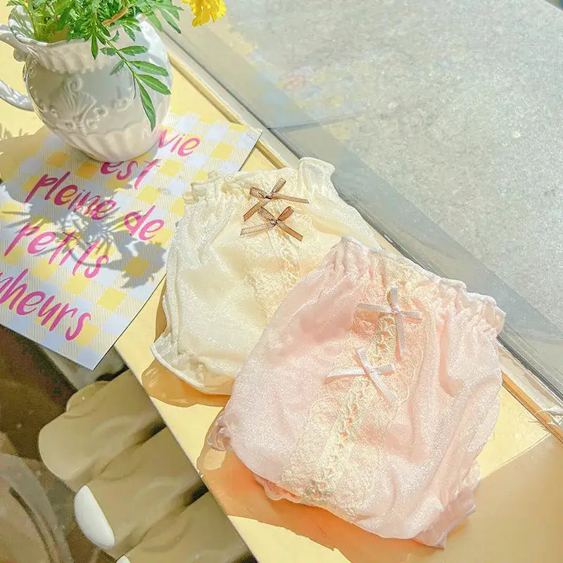 Ice silk women's panties two-pack in cream and pink with bows, lace trim, and elastic waist