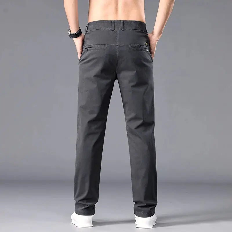 Casual men's straight-fit chinos in dark gray, back view with belt loops and back pockets.