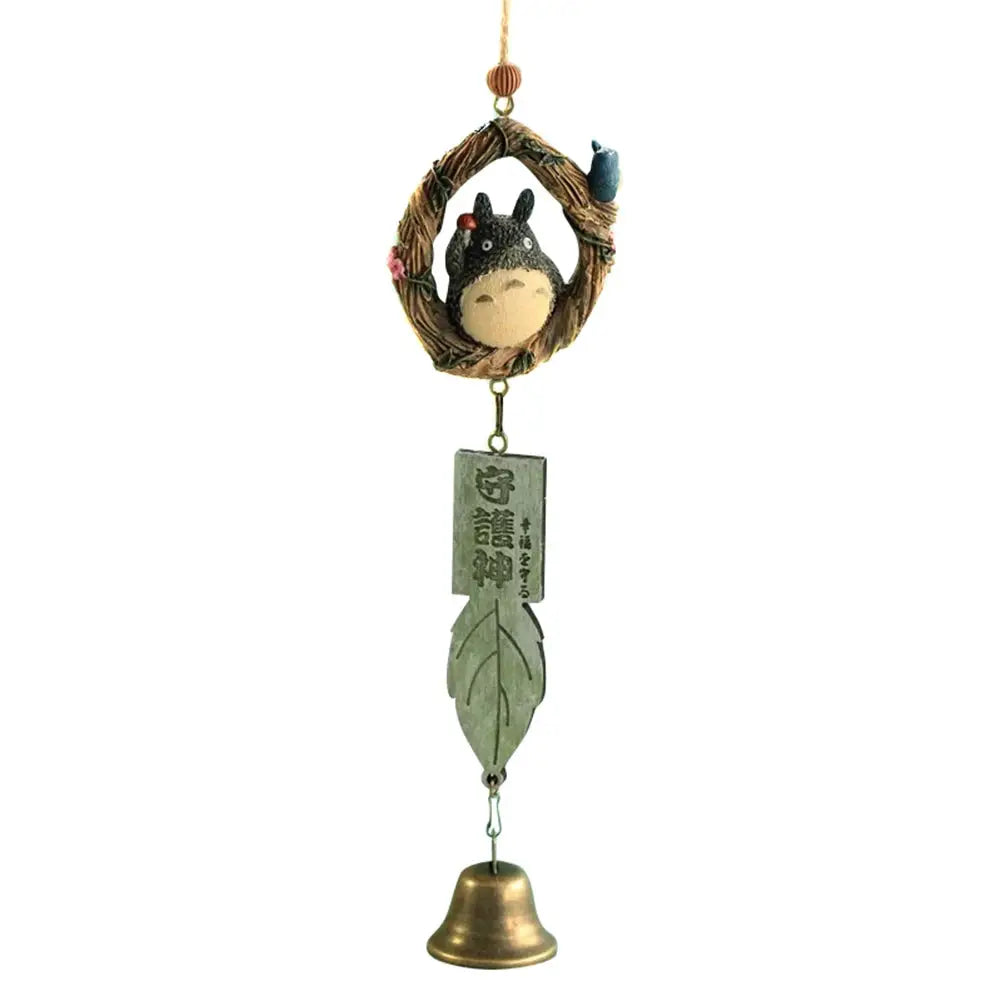 Resin wind chime ornament featuring gray creature inside circular wreath with a green leaf charm and brass bell