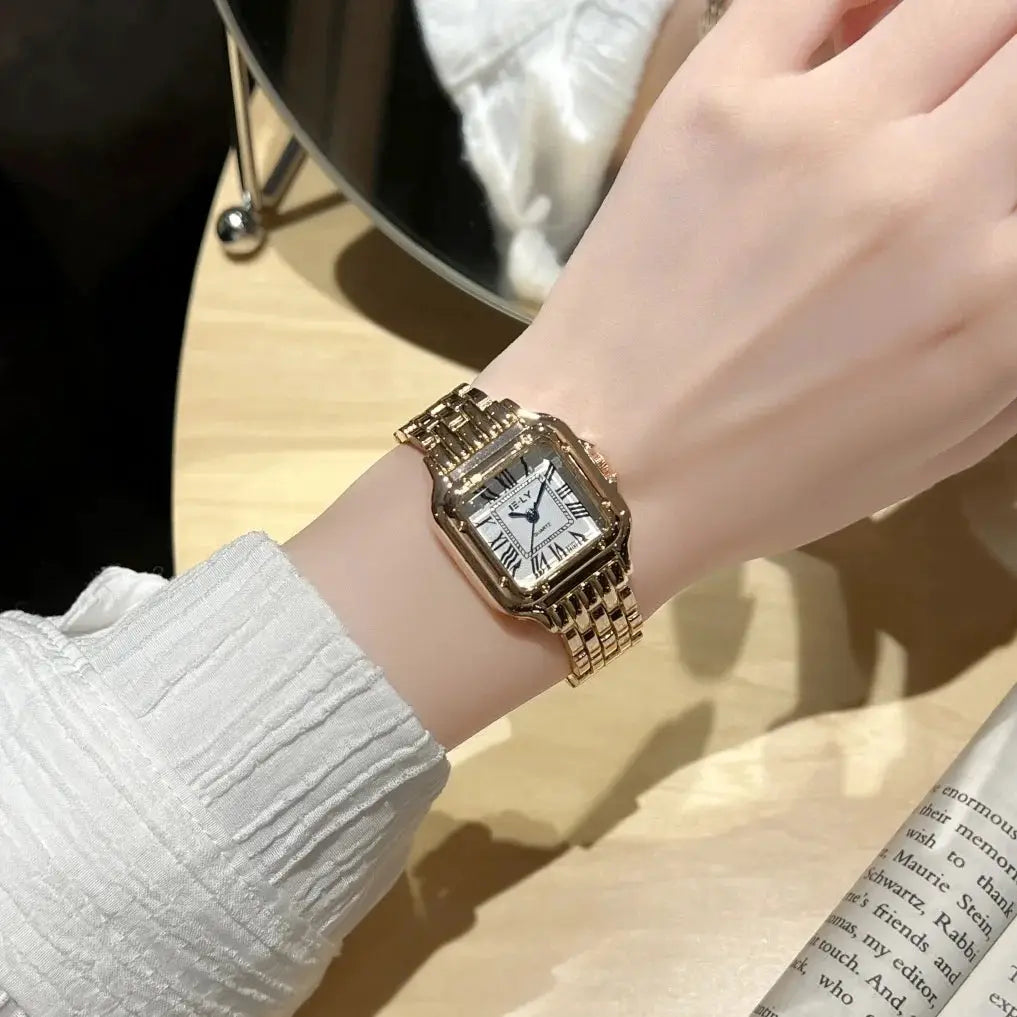 Women's gold stainless steel wristwatch with bracelet band and Roman numeral dial, quartz movement