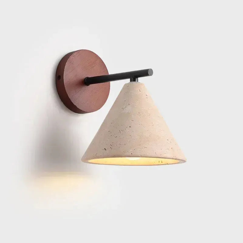 Wall lamp by Simples Market; travertine cone shade, round wooden backplate, black arm.