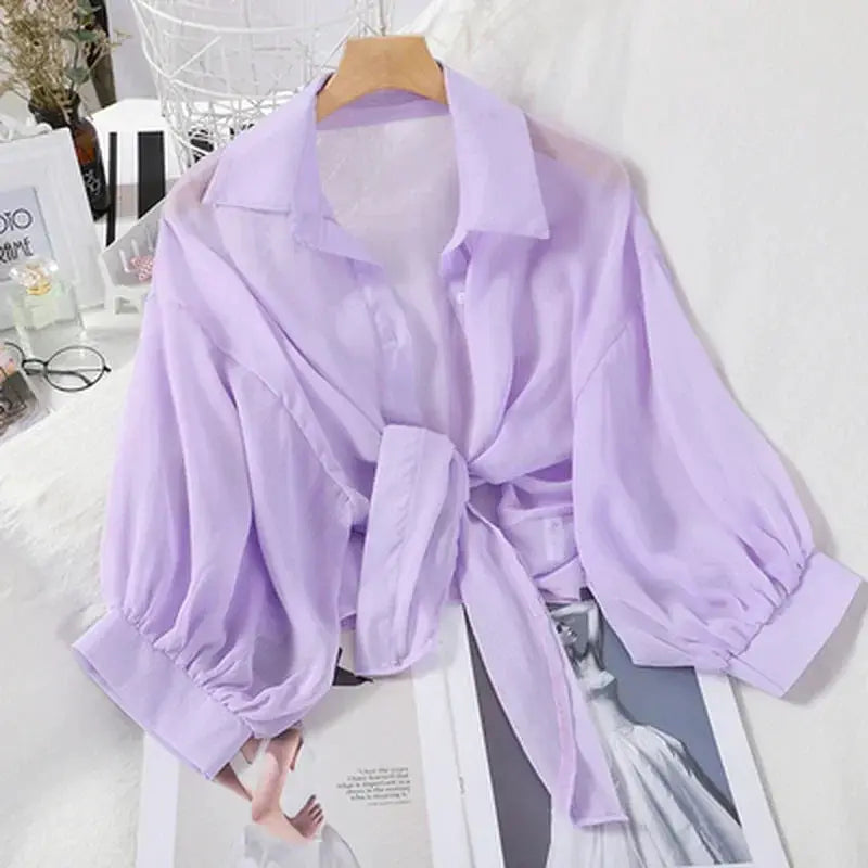 Lavender chiffon blouse with tie-front waist and bat-style sleeves.