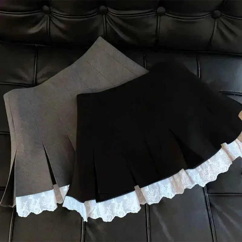 Flume edge lace skirts by Simples Market, two pleated A-line skirts in grey and black with white lace trim.