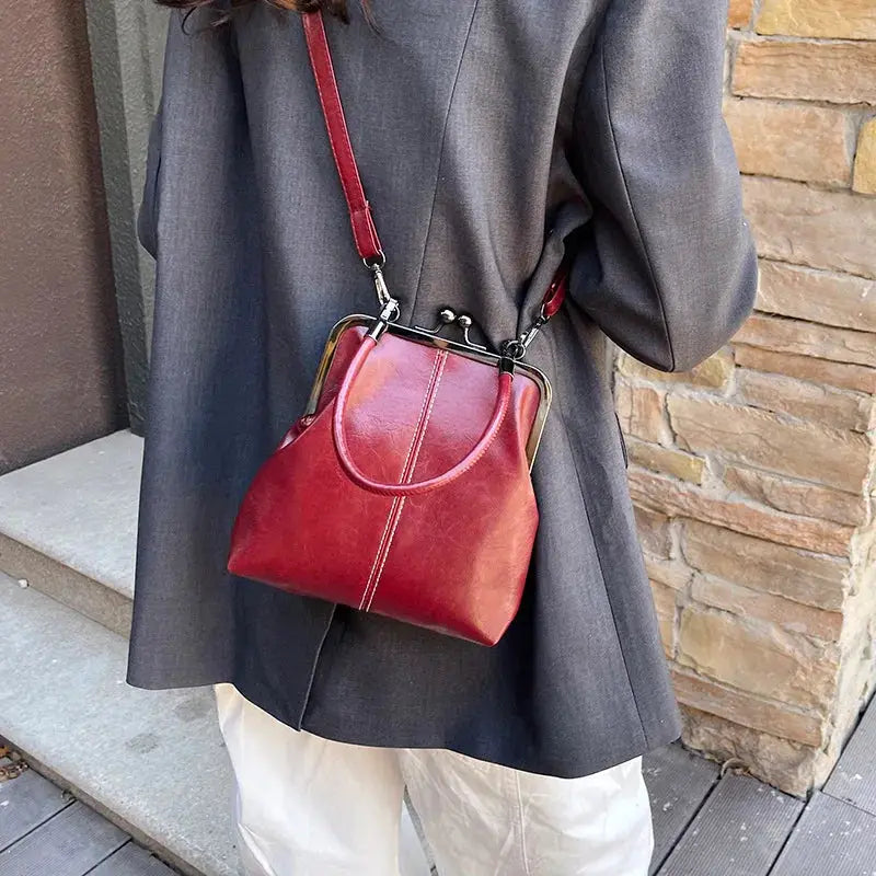 Vintage-style women's handbag burgundy PU leather with metal-frame top, crossbody bag.