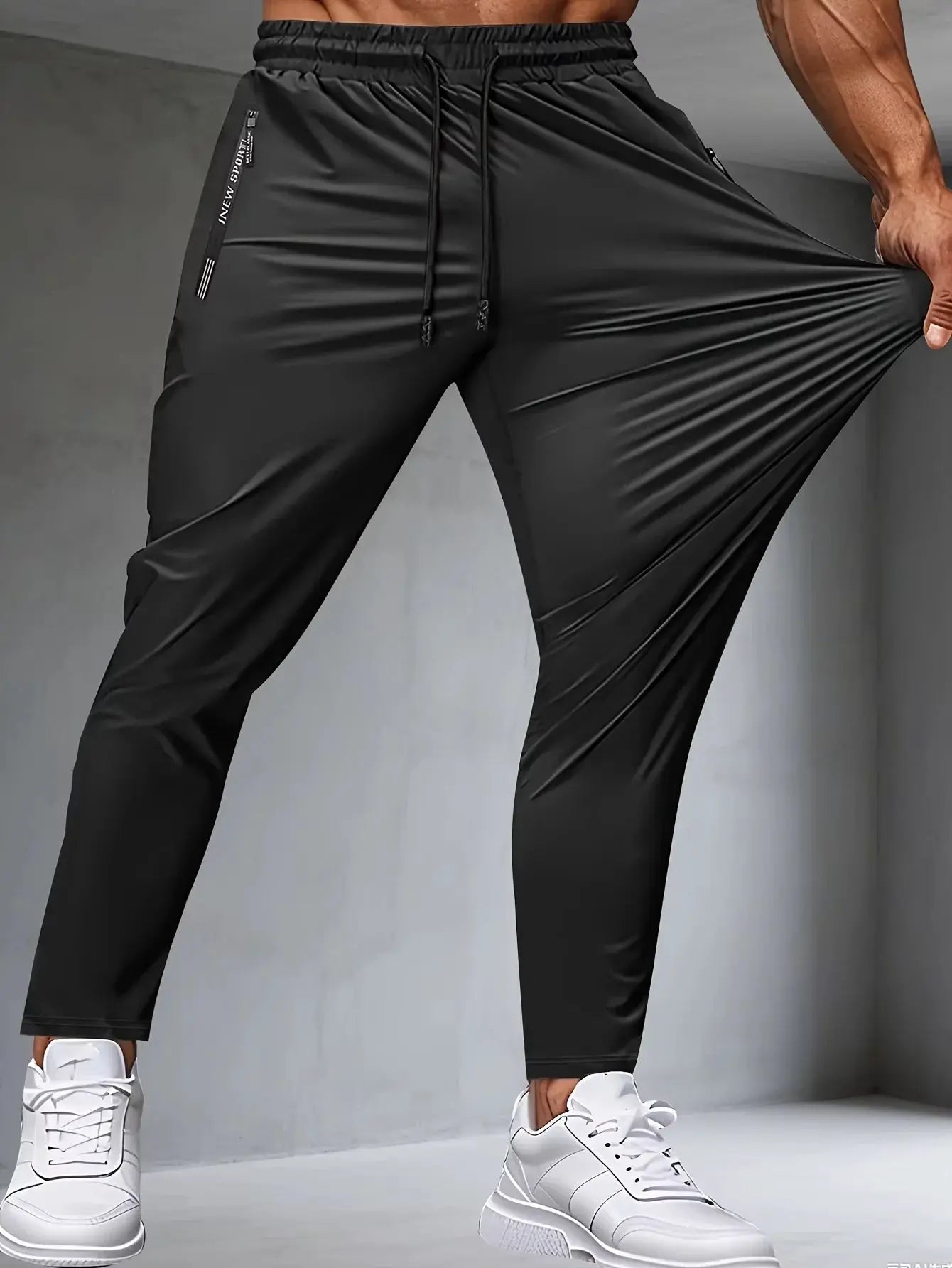 Men's fitness jogger pants with zippered pockets and stretch fabric for running and gym workouts