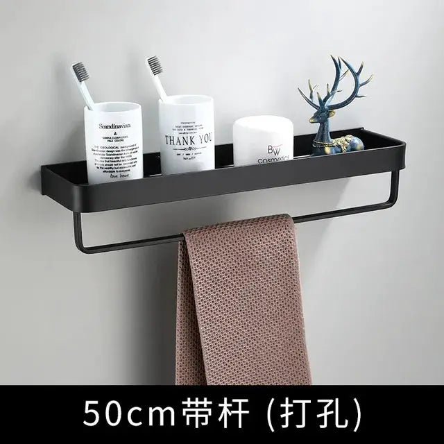 50cm black aluminum bathroom corner shelf, wall-mounted with towel bar, holding toothbrush cups and decor.