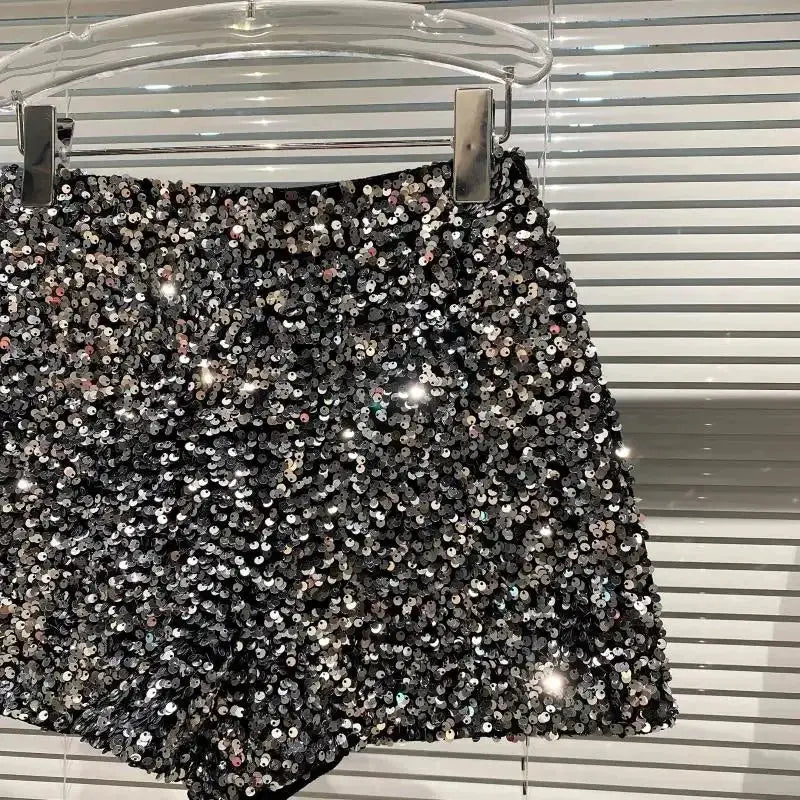 Women's black sequin shorts on hanger, shiny clubwear hot pants with high-street style