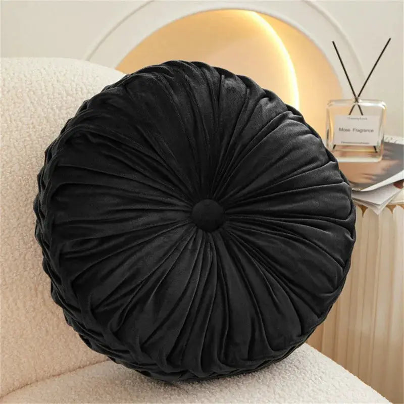 Round black velvet throw pillow with hand-sewn pleated 3D pumpkin center for lumbar back support on sofa, bed, or chair
