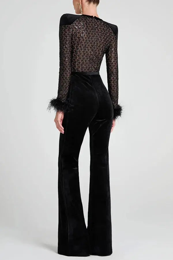 Black velvet jumpsuit by Simples Market with gold patchwork mesh top, long sleeves, feather cuffs, back view