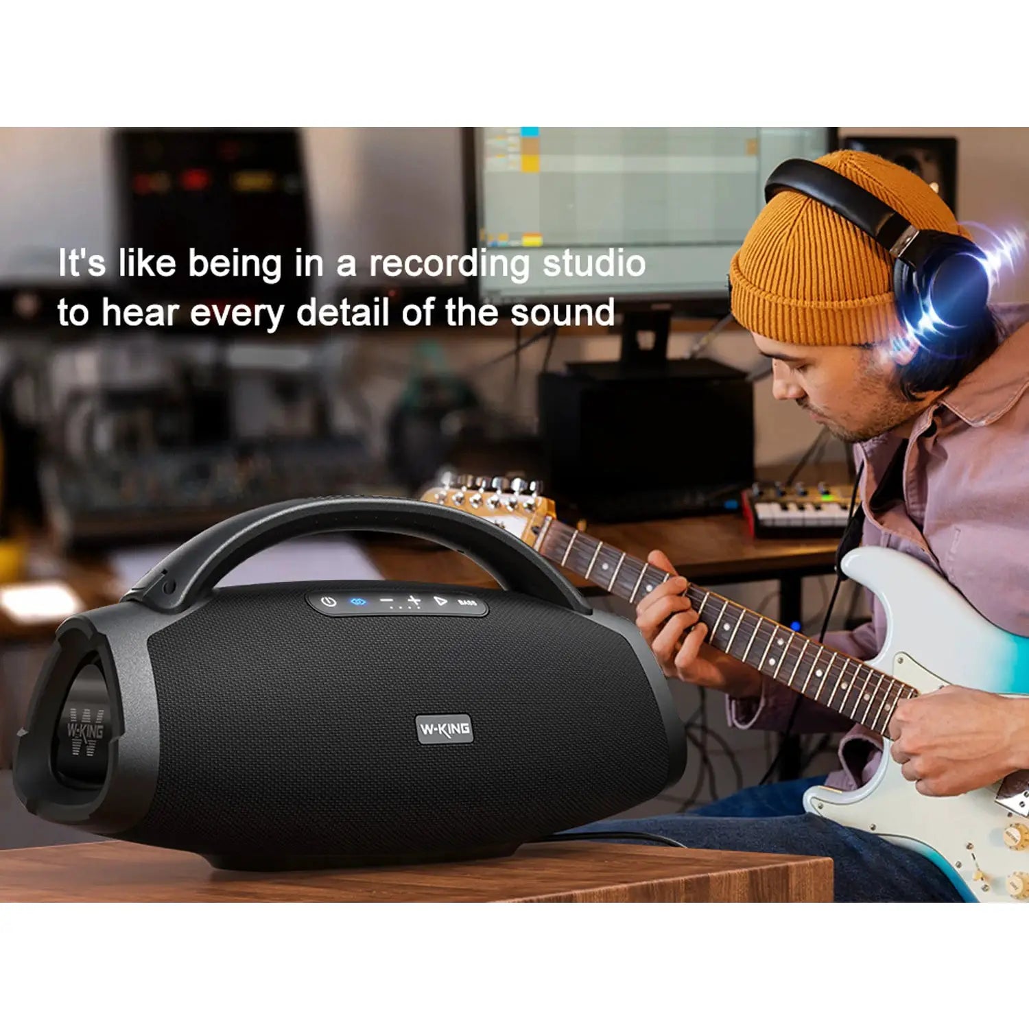 W-KING X20 portable Bluetooth speaker, black with built-in handle; guitarist in orange beanie in a studio.