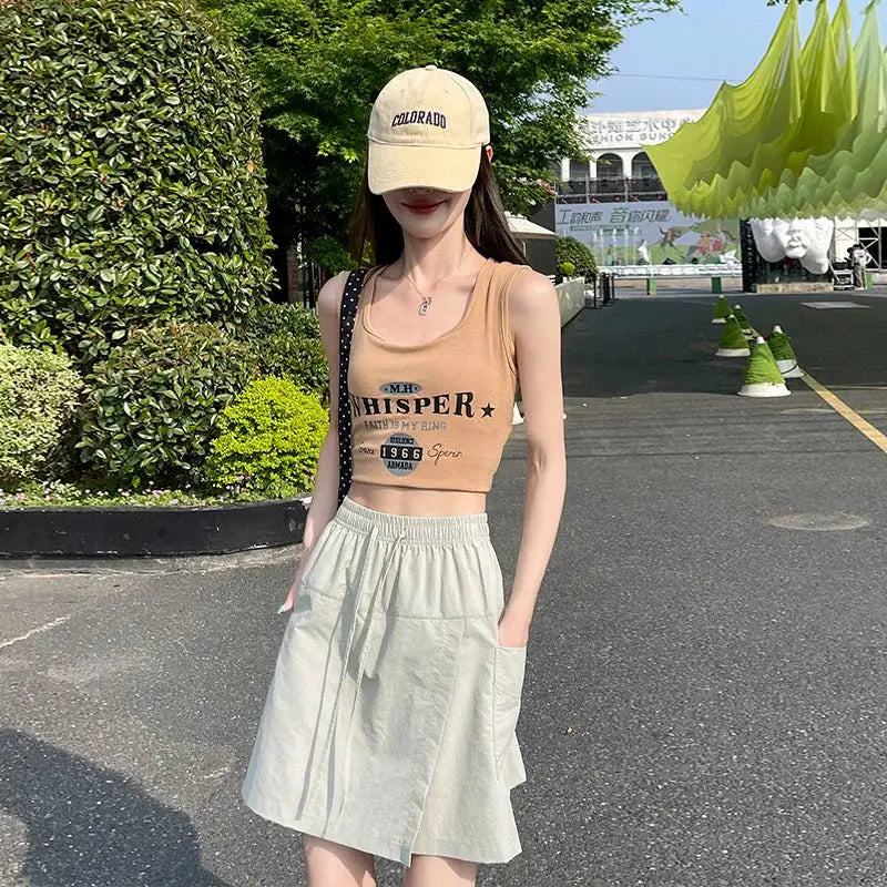 Two-piece shorts-skirt set for women, high-waist mini in light beige with A-line silhouette and side slit.
